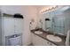 Bathroom featuring double sinks, a large mirror with vanity lighting and neutral décor at 2060 Willow Hammock Cir # 207, Punta Gorda, FL 33983