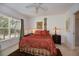 Cozy bedroom with a large window providing natural light, ceiling fan, and closet at 2060 Willow Hammock Cir # 207, Punta Gorda, FL 33983