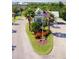 Community entrance with an American flag, palm trees, and beautifully landscaped grounds at 2060 Willow Hammock Cir # 207, Punta Gorda, FL 33983