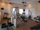 Well-equipped community gym with treadmills, weight machines, and multiple ceiling fans at 2060 Willow Hammock Cir # 207, Punta Gorda, FL 33983