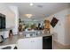 Kitchen with stainless steel sink and appliances and open view to the dining room and the living room at 2060 Willow Hammock Cir # 207, Punta Gorda, FL 33983
