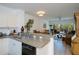 Open concept kitchen with view to living room, dining area, and balcony beyond at 2060 Willow Hammock Cir # 207, Punta Gorda, FL 33983