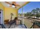 Inviting screened lanai with a chaise lounge, table, and chairs overlooking mature landscaping at 2060 Willow Hammock Cir # 207, Punta Gorda, FL 33983