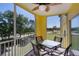 Screened lanai with a ceiling fan and outdoor seating, offering a lovely neighborhood view at 2060 Willow Hammock Cir # 207, Punta Gorda, FL 33983