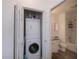 Efficient laundry closet next to the bathroom featuring a stacked washer and dryer at 2060 Willow Hammock Cir # 207, Punta Gorda, FL 33983