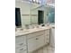 Bathroom featuring double vanity sink, large mirror and white cabinets with brushed silver hardware at 2095 Ellery St, Port Charlotte, FL 33952