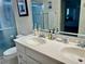 Bright bathroom featuring a double vanity sink, framed mirror and shower with glass doors at 2095 Ellery St, Port Charlotte, FL 33952