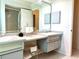 Bathroom featuring double sinks and vanity storage at 2095 Ellery St, Port Charlotte, FL 33952