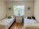 Bedroom featuring twin beds, a dresser and window with white blinds at 2095 Ellery St, Port Charlotte, FL 33952