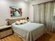 Cozy bedroom featuring a queen bed, with a light blue quilt and wooden floors at 2095 Ellery St, Port Charlotte, FL 33952