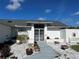 Inviting front entrance features gated double doors, decorative rock landscaping, and a charming arched window at 2095 Ellery St, Port Charlotte, FL 33952