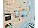 Kitchen with white cabinetry offers views into the living and dining areas at 2095 Ellery St, Port Charlotte, FL 33952