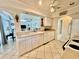 Bright kitchen with white cabinetry and views of the living area at 2095 Ellery St, Port Charlotte, FL 33952