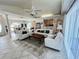 Open-concept living room with tile floors, vaulted ceilings, and seamless flow to dining and kitchen at 2095 Ellery St, Port Charlotte, FL 33952