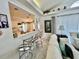 Bright living room features a partial view of the kitchen and stylish bar seating at 2095 Ellery St, Port Charlotte, FL 33952