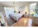 The main bedroom has wood floors, bright windows, and a ceiling fan at 2095 Ellery St, Port Charlotte, FL 33952