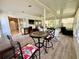 Bright sunroom featuring large windows, wood-look floors and multiple seating areas at 2095 Ellery St, Port Charlotte, FL 33952