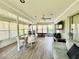 Bright sunroom featuring large windows, wood-look floors and a ceiling fan at 2095 Ellery St, Port Charlotte, FL 33952