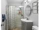Well-lit bathroom featuring modern fixtures, a shower, and a vanity, designed for comfort and convenience at 2201 Birchcrest Blvd, Port Charlotte, FL 33952