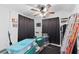 Bedroom featuring a ceiling fan, window AC unit, and storage containers at 2201 Birchcrest Blvd, Port Charlotte, FL 33952