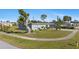 Charming single-story home with mature landscaping and a well manicured lawn at 2201 Birchcrest Blvd, Port Charlotte, FL 33952