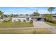 Charming single-story home with a well-maintained lawn, covered carport, and a welcoming screened entry at 2201 Birchcrest Blvd, Port Charlotte, FL 33952