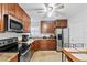 Well-equipped kitchen featuring stainless steel appliances, wood cabinetry, and ample counter space for meal prep at 2201 Birchcrest Blvd, Port Charlotte, FL 33952