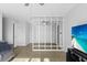 Comfortable living room featuring a wall partition, providing a modern touch, complemented by a TV and fan at 2201 Birchcrest Blvd, Port Charlotte, FL 33952