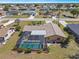 Aerial shot of a charming home featuring a screened-in pool, lush landscaping, and a well-maintained backyard at 2333 Rio De Janeiro Ave, Punta Gorda, FL 33983