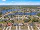 Aerial view of neighborhood showcasing lake, mature trees, and nearby homes at 2333 Rio De Janeiro Ave, Punta Gorda, FL 33983