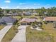 Aerial shot of a cozy single-story home with a long driveway and a well-maintained yard in a quiet neighborhood at 2333 Rio De Janeiro Ave, Punta Gorda, FL 33983