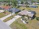 Wide aerial view of a home with desert landscaping, palm trees, and a long driveway in a suburban neighborhood at 2333 Rio De Janeiro Ave, Punta Gorda, FL 33983