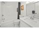 Bright white bathroom features shower-tub combo and modern sink at 2333 Rio De Janeiro Ave, Punta Gorda, FL 33983