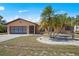 Charming single-story home featuring a well-manicured lawn, mature palms, and a two-car garage at 2333 Rio De Janeiro Ave, Punta Gorda, FL 33983