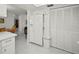 Bright kitchen featuring white appliances, white cabinetry and large pantry at 2333 Rio De Janeiro Ave, Punta Gorda, FL 33983