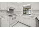 Bright kitchen with white appliances, countertops, and updated flooring at 2333 Rio De Janeiro Ave, Punta Gorda, FL 33983