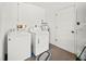 This well-lit laundry room is equipped with a washer, dryer, and a water heater at 2333 Rio De Janeiro Ave, Punta Gorda, FL 33983