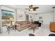 Cozy living room with large windows, ceiling fan and neutral decor at 2333 Rio De Janeiro Ave, Punta Gorda, FL 33983