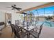 A screened-in lanai features a dining set with a view of the sparkling pool at 2333 Rio De Janeiro Ave, Punta Gorda, FL 33983