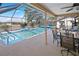 Covered and screened patio area with outdoor table set and pool at 2333 Rio De Janeiro Ave, Punta Gorda, FL 33983