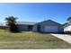 Charming single-story home featuring an attached garage and well-maintained lawn at 234 Shadow Nw St, Port Charlotte, FL 33952