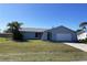 Charming single-story home featuring a well-maintained lawn and a welcoming, arched entryway at 234 Shadow Nw St, Port Charlotte, FL 33952