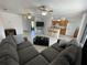 Spacious living room featuring ceiling fans and an open layout to the kitchen at 234 Shadow Nw St, Port Charlotte, FL 33952