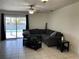 Comfortable living room featuring a large sectional sofa and sliding door access to the backyard pool area at 234 Shadow Nw St, Port Charlotte, FL 33952
