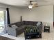Relax in this inviting living room with a comfortable gray couch and a ceiling fan at 234 Shadow Nw St, Port Charlotte, FL 33952
