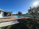 Backyard pool with brick paver surround, adjacent deck, and grassy lawn at 234 Shadow Nw St, Port Charlotte, FL 33952