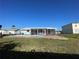 Backyard pool with enclosed screened-in lanai and partial view of adjacent homes at 234 Shadow Nw St, Port Charlotte, FL 33952