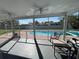 View from screened porch of a private swimming pool with a brick surround at 234 Shadow Nw St, Port Charlotte, FL 33952