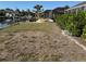 Spacious waterfront backyard with lush grass, seawall and a dock for boat access, perfect for outdoor enjoyment at 285 Bal Harbor Blvd, Punta Gorda, FL 33950