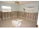 Bathroom awaiting renovations featuring exposed block wall, toilet, and window at 285 Bal Harbor Blvd, Punta Gorda, FL 33950